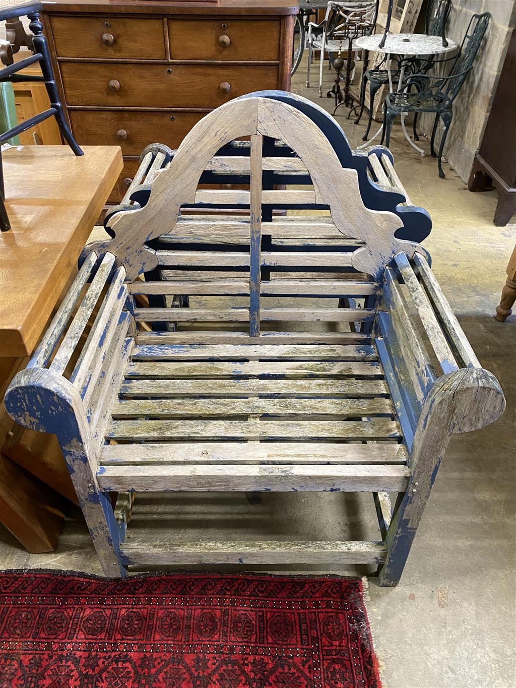 A pair of Lutyens style weathered teak garden chairs, width 94cm, depth 62cm, height 104cm